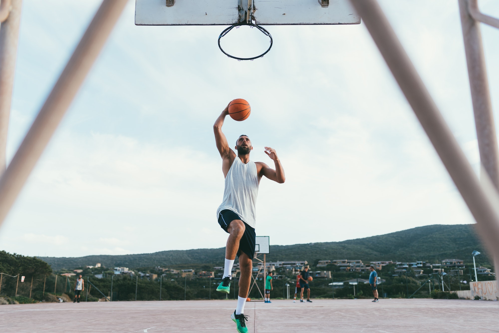 young man bearded playing basketball sport slam dunk